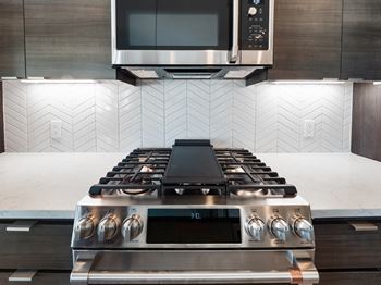 a kitchen with a stove and a microwave at Scottsdale Grand, Arizona, 85260